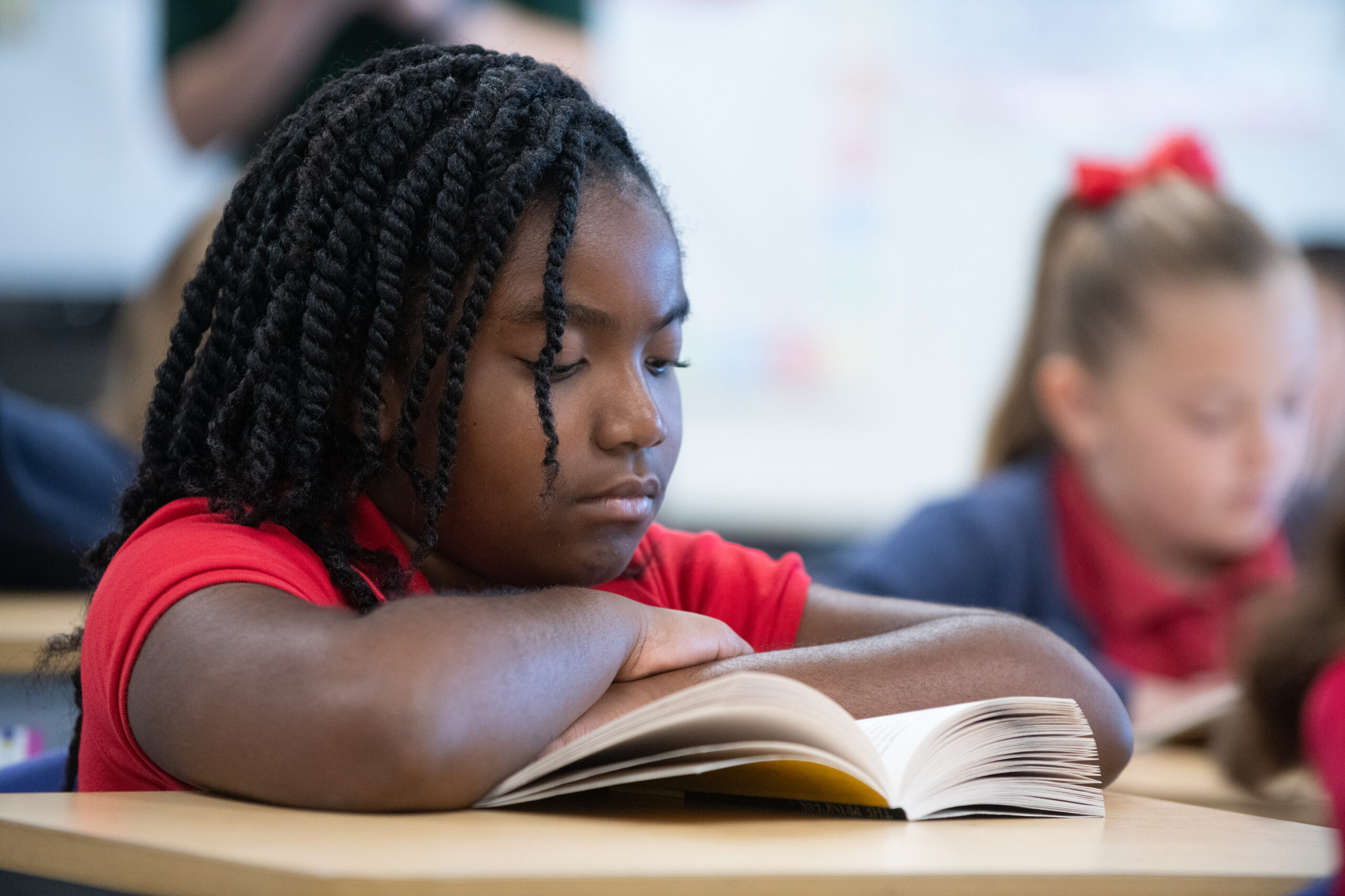 young girl reading at her desk