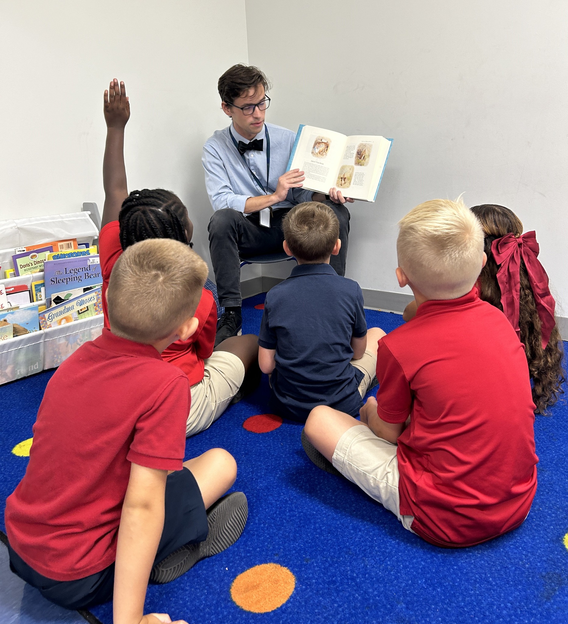 Male teacher reading to students